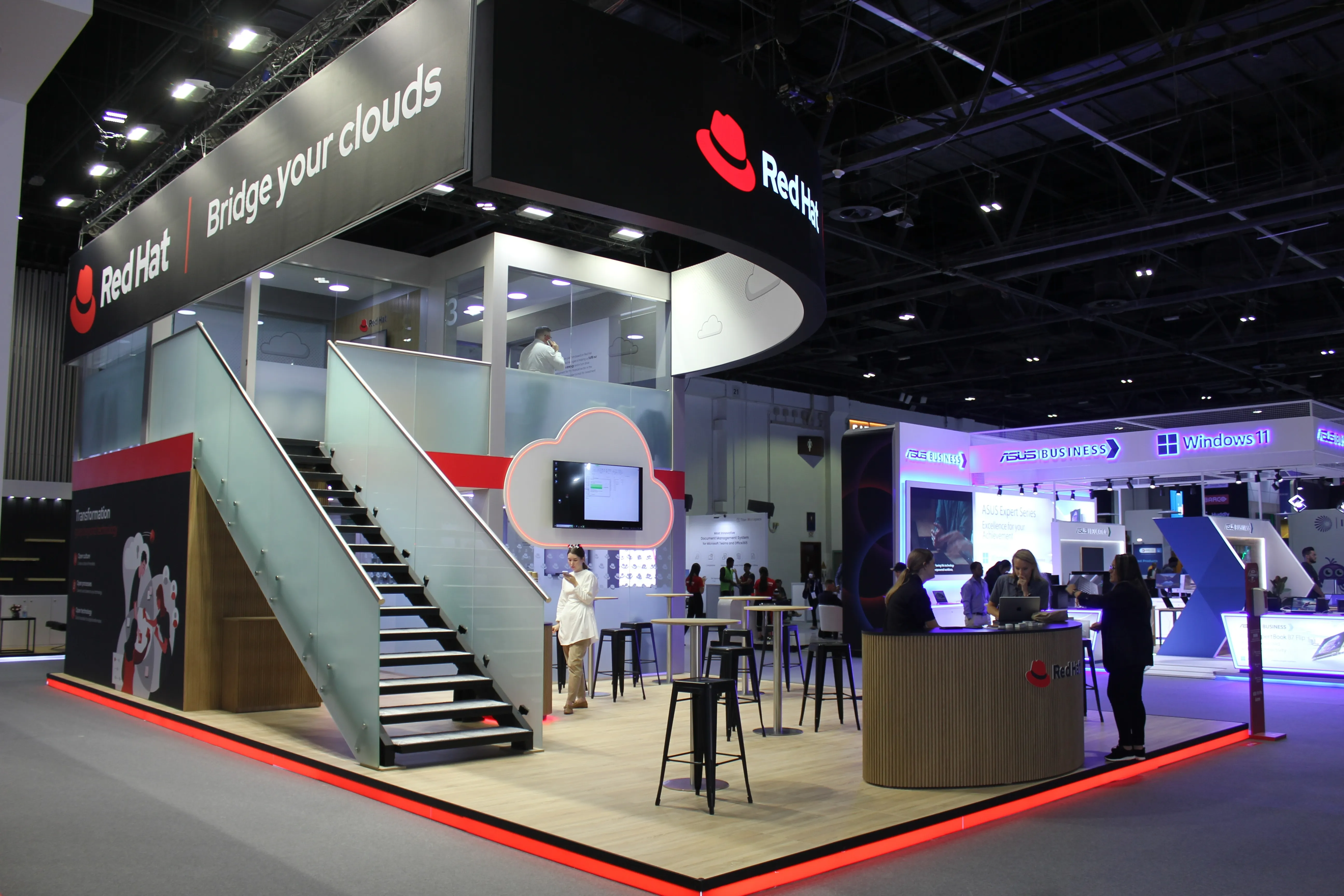 Custom exhibition stand with a branded reception and meeting area