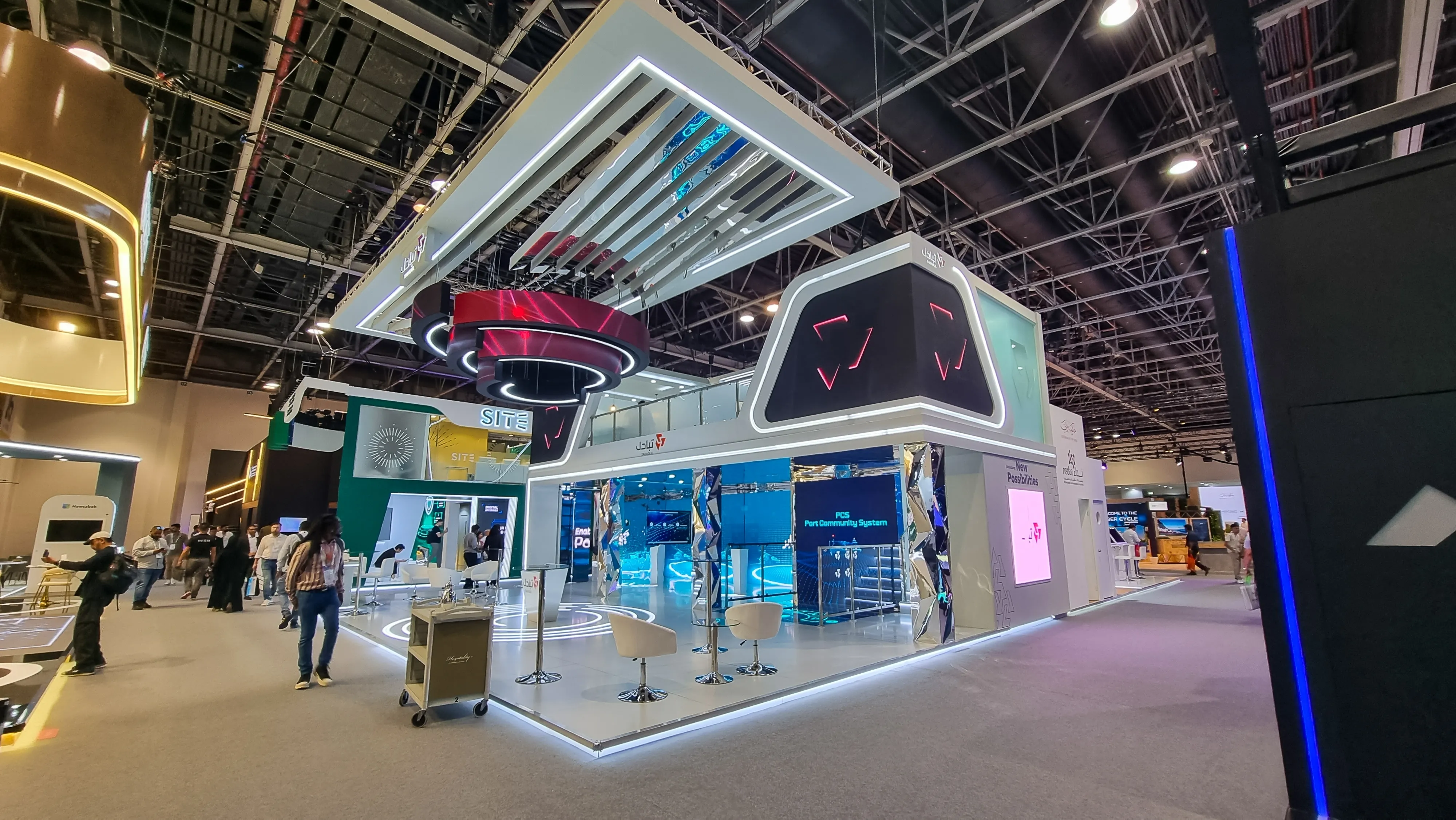 Lounge-style exhibition stand with branded furniture and plants